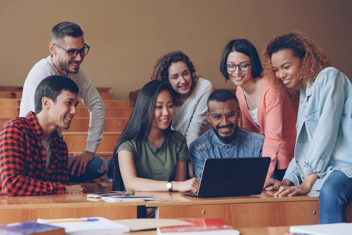 University students studying together around a laptop