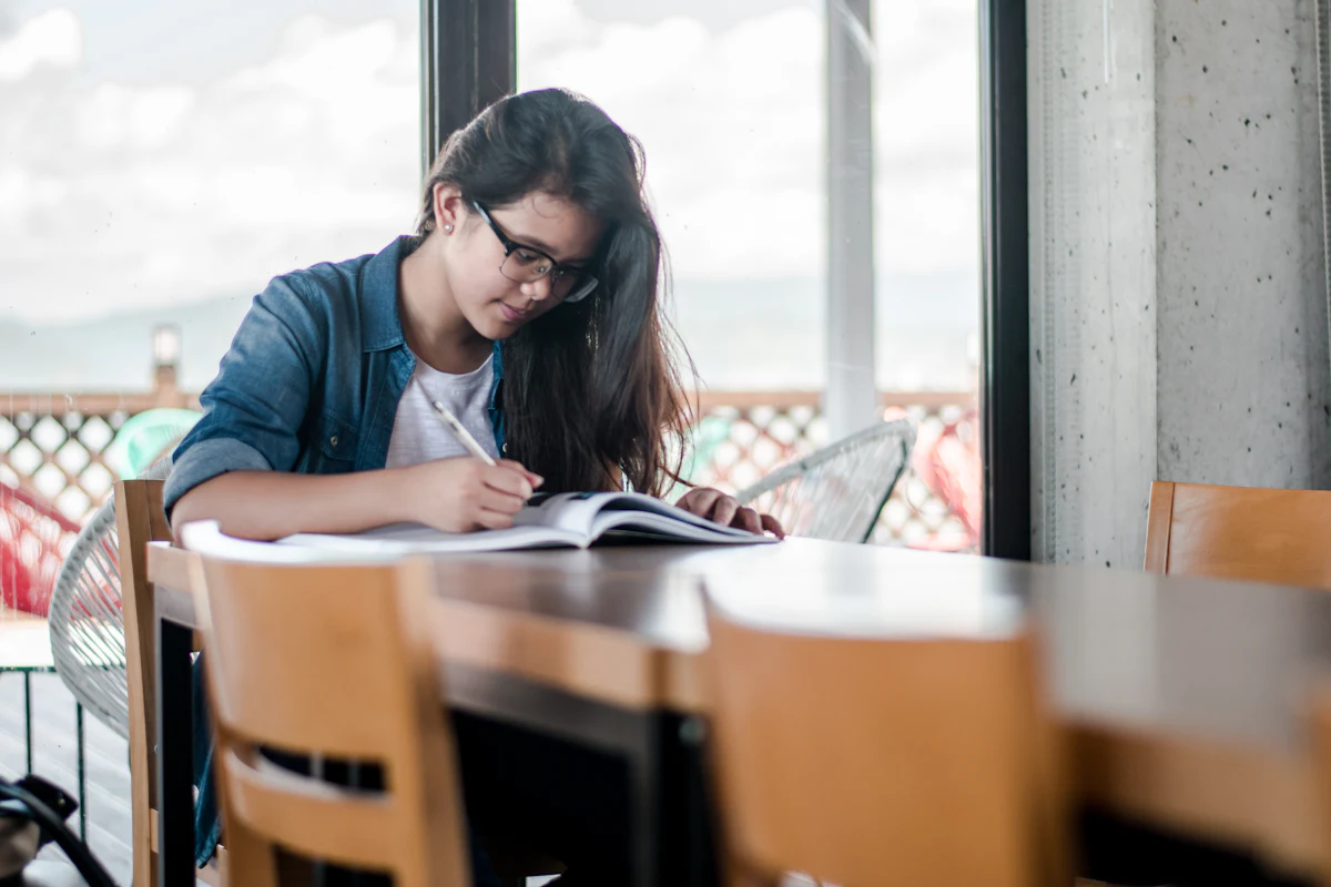 Student reading and taking notes for research
